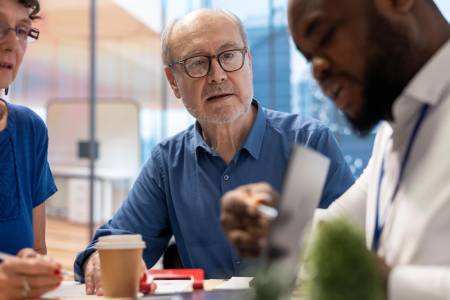Mature couple discussing retirement strategy with a financial planner
